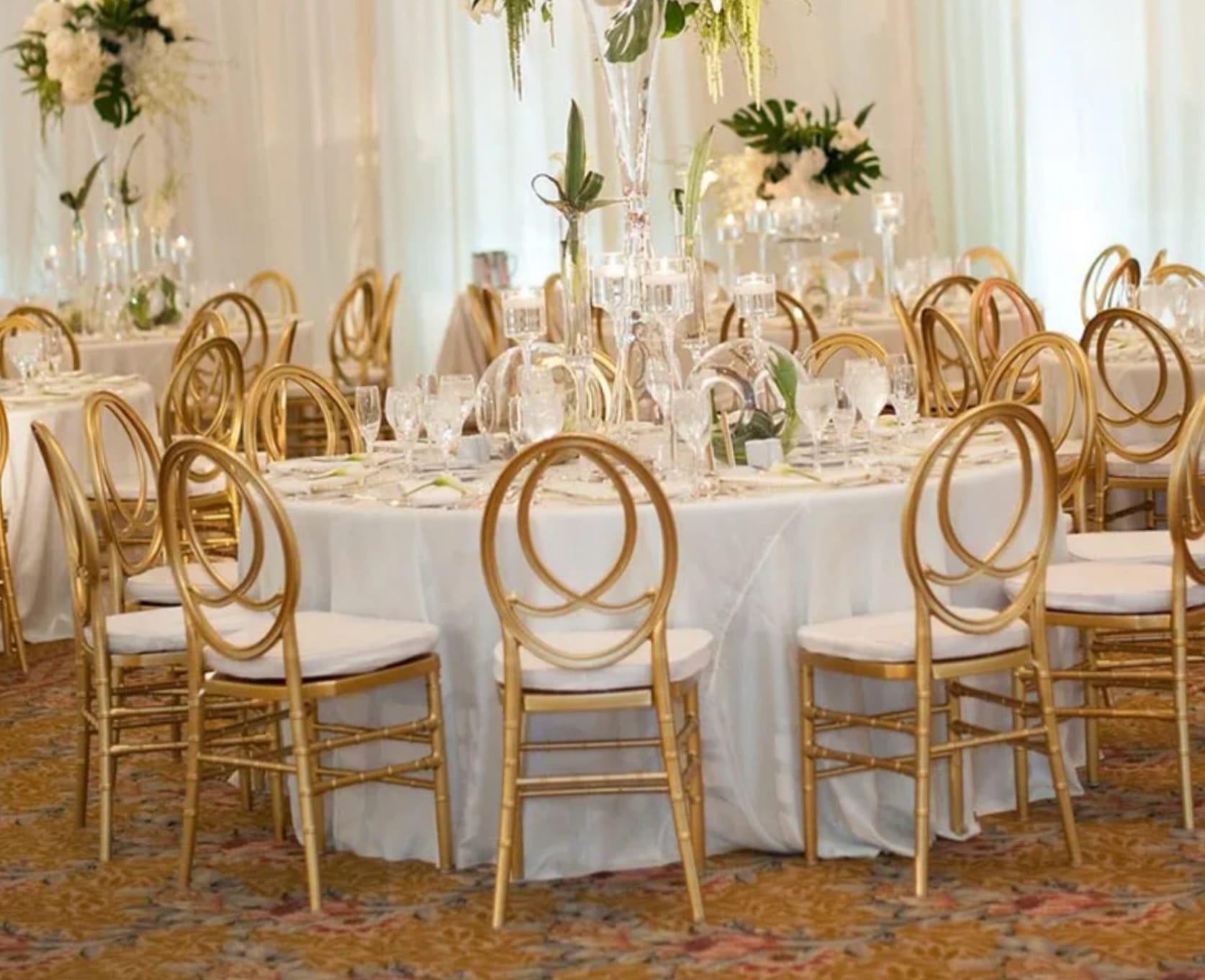 Gold Chiavari event chair with bamboo-style frame and white cushion
