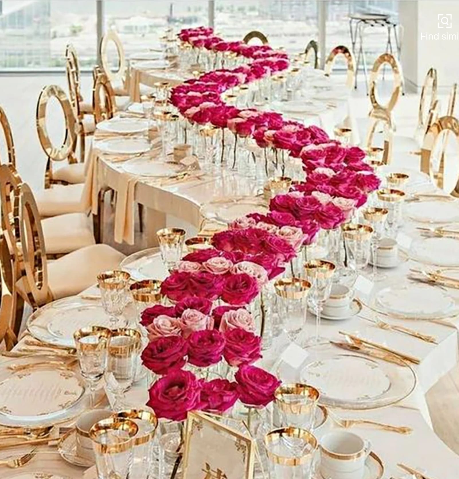 Banquet table with Classic Gold Circle chairs and a long runner of pink and red roses down the center